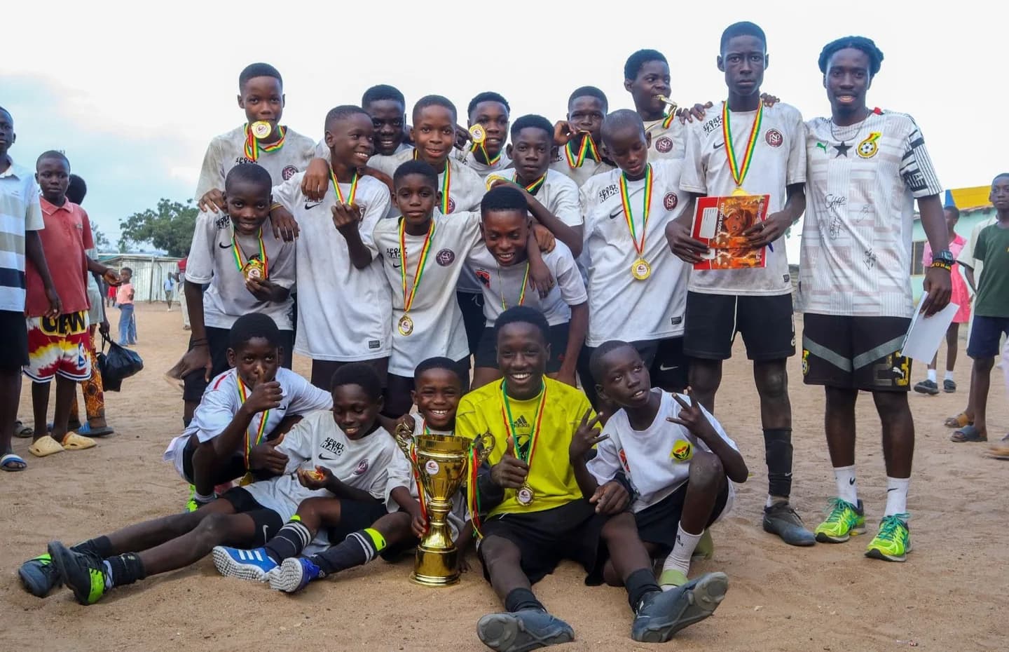 Champions celebrating with the tournament trophy and medals
